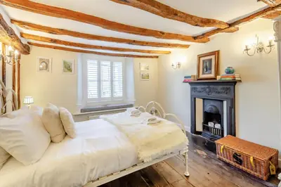 a bedroom with a bed and a fireplace at 4 Bed in Cartmel oc-d31802 in Cartmel