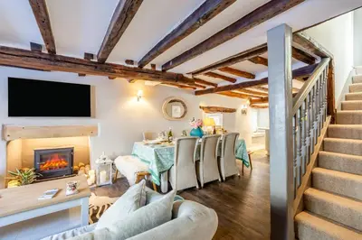a living room with a table and chairs and a fireplace at 4 Bed in Cartmel oc-d31802 in Cartmel