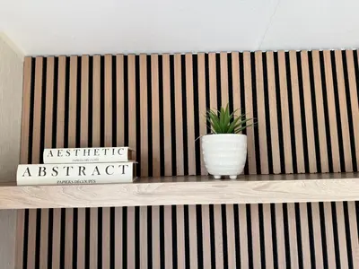 a plant in a white vase sitting on a shelf at Miarlo Lodge Rydal Haven Lakeland in Flookburgh