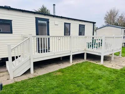 a house with a white deck and a house at Miarlo Lodge Rydal Haven Lakeland in Flookburgh