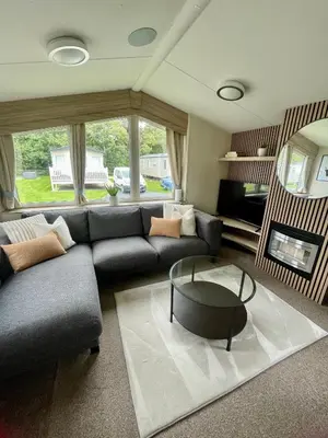 a living room with a couch and a coffee table at Miarlo Lodge Rydal Haven Lakeland in Flookburgh