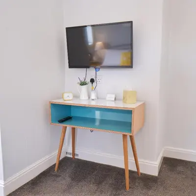 a desk with a tv on top of it at Corner Beech House in Grange Over Sands