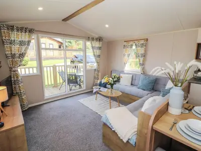 a living room with a couch and a table at Barney's Retreat - Docker Park Farm in Carnforth