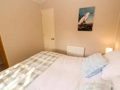 a bedroom with a bed and a picture on the wall at Barney's Retreat - Docker Park Farm in Carnforth