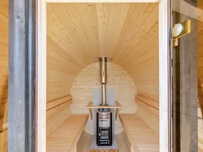an interior of a sauna with a wooden ceiling at Barn Owl Lodge - Uk49903 in Appley Bridge