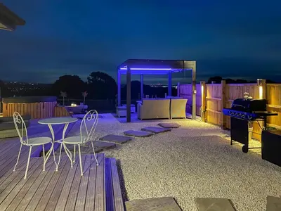 a patio with a table and chairs and a grill at Barn Owl Lodge - Uk49903 in Appley Bridge