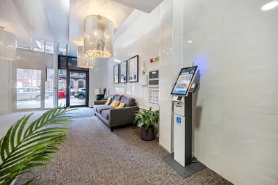 a lobby with a tv and a couch in a building at Spectacular Central Apartment Free Parking Sleep 7 in Liverpool