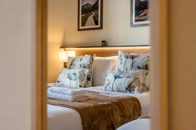 a reflection of a bedroom with a bed in a mirror at Spectacular Central Apartment Free Parking Sleep 7 in Liverpool