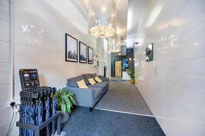 a living room with a couch and a chandelier at Spectacular Central Apartment Free Parking Sleep 7 in Liverpool