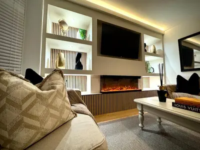 a living room with a couch and a fireplace at Keswick Hot Tub Family House in Lytham St Annes
