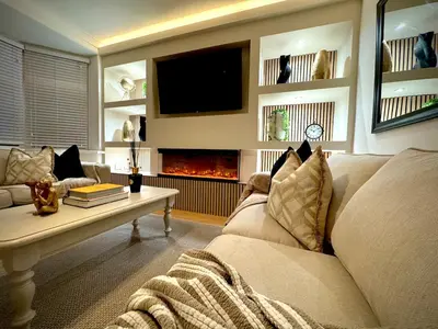 a living room with a couch and a fire place at Keswick Hot Tub Family House in Lytham St Annes