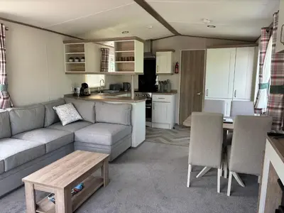 a living room with a couch and a table and a kitchen at 10 Borwick Lakes, Carnforth - En suite - King size bed in Carnforth