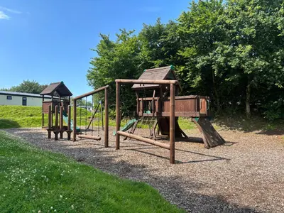 a row of playground equipment in a park at 10 Borwick Lakes, Carnforth - En suite - King size bed in Carnforth