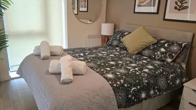 a bedroom with a bed with towels on it at Gorgeous GF 2 Bed 2 bathroom Apartment Liverpool 3 in Liverpool