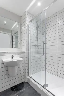 a white bathroom with a sink and a shower at Gorgeous GF 2 Bed 2 bathroom Apartment Liverpool 3 in Liverpool