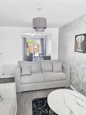 a living room with a couch and a table at 3BR with Ensuite & Downstairs WC in Litherland