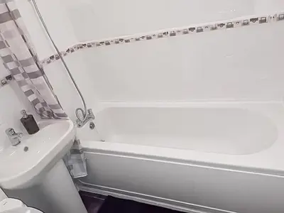 a bathroom with a sink and a tub and a toilet at 3BR with Ensuite & Downstairs WC in Litherland