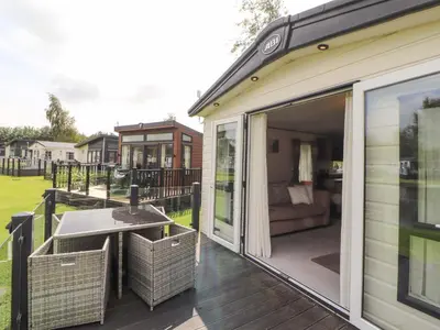 a screened in porch with a table and a couch at 22 Yealand in Carnforth