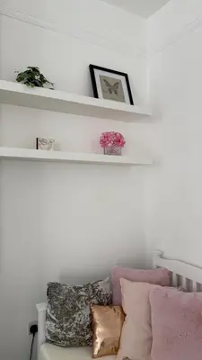 a living room with white shelves and a couch at Santiago Suites in Southport