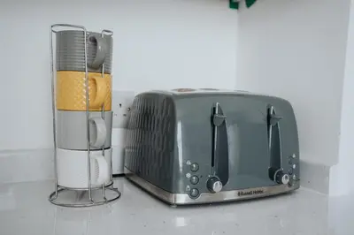 a toaster and a toaster oven sitting on a counter at Santiago Suites in Southport