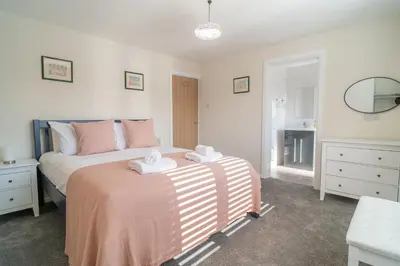 a bedroom with a bed with two towels on it at Southport Retreat in Ainsdale