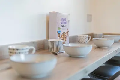 a counter with several bowls and cups on it at Southport Retreat in Ainsdale