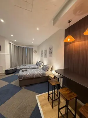 a bedroom with a bed and a couch in it at Almar Hotel Apartments Blackpool in Blackpool