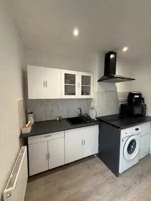 a kitchen with a sink and a washing machine at Almar Hotel Apartments Blackpool in Blackpool