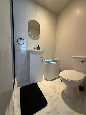 a bathroom with a toilet and a shower and a sink at Almar Hotel Apartments Blackpool in Blackpool
