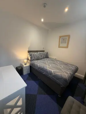 a bedroom with a bed and a table in it at Almar Hotel Apartments Blackpool in Blackpool
