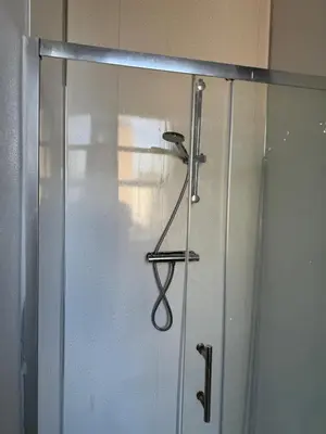 a sliding glass door with a hanger on it at Almar Hotel Apartments Blackpool in Blackpool