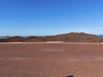 an empty desert with a mountain in the background at Beauty Abounds in Morecambe