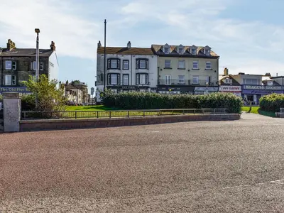 an empty street in front of buildings at The Croston in Morecambe