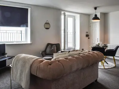 a living room with a couch and a chair at The Croston in Morecambe
