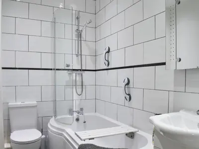 a bathroom with a shower and a sink and a toilet at The Croston in Morecambe