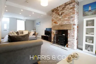 a living room with a couch and a fireplace at Captain's Cove in Fleetwood