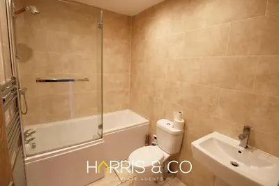 a bathroom with a shower and a toilet and a sink at Captain's Cove in Fleetwood
