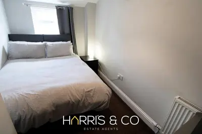 a small bedroom with a bed and a window at Captain's Cove in Fleetwood