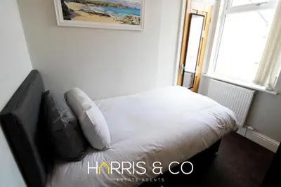 a small bed in a room with a window at Captain's Cove in Fleetwood