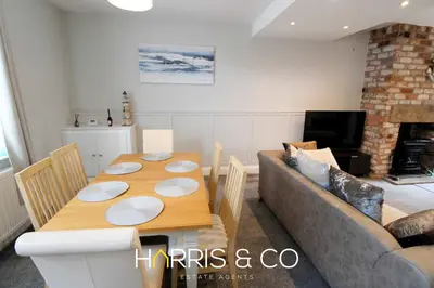 a living room with a table and a couch at Captain's Cove in Fleetwood