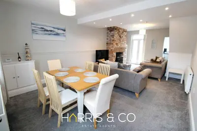 a dining room and living room with a table and a couch at Captain's Cove in Fleetwood