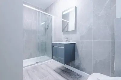 a bathroom with a sink and a shower at Elysée Suites - Stunning 1 Bed Flat in Southport in Southport