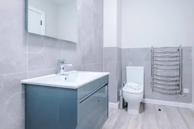 a bathroom with a sink and a toilet at Elysée Suites - Stunning 1 Bed Flat in Southport in Southport