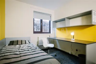 a bedroom with a desk and a bed and a window at Waddell Hall, University of Cumbria in Lancaster