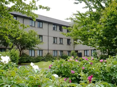 an apartment building with flowers in front of it at Waddell Hall, University of Cumbria in Lancaster
