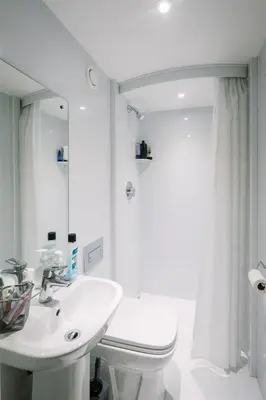 a bathroom with a sink and a toilet and a mirror at Waddell Hall, University of Cumbria in Lancaster