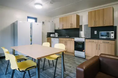 a kitchen with a table and chairs and a couch at Waddell Hall, University of Cumbria in Lancaster