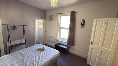 a bedroom with a bed and a window at Blackpool Pleasure Beach whole Holiday Home! in Blackpool