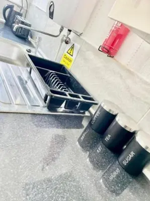 a dish drying rack with two cups on it at Blackpool Pleasure Beach whole Holiday Home! in Blackpool