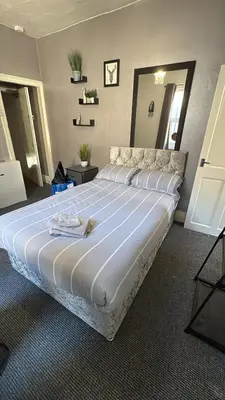 a bedroom with a large bed in a room at Blackpool Pleasure Beach whole Holiday Home! in Blackpool